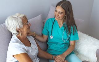 older woman talking with hospice inpatient care nurse