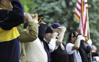 WWII veterans saluting fallen soldiers at funeral service at Riverside National Cemetery