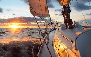 yacht sailing into the sunset off the coast of San Diego