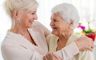 a death doula embracing an elderly patient at their home near Malibu, CA